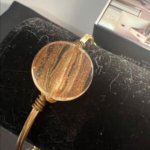 Bourbon and Boweties bangle features 3 Gold flecked beads and a signature logo